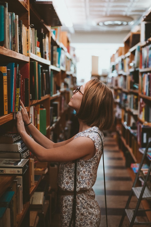 student looking for book at a selective school library