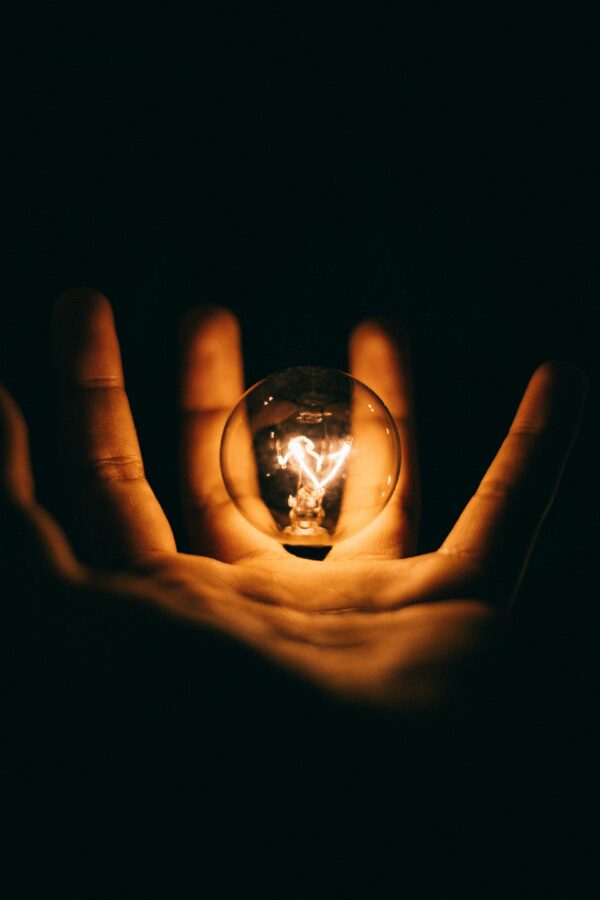 a man holding a light bulb after reading tips for the selective school test thinking skills